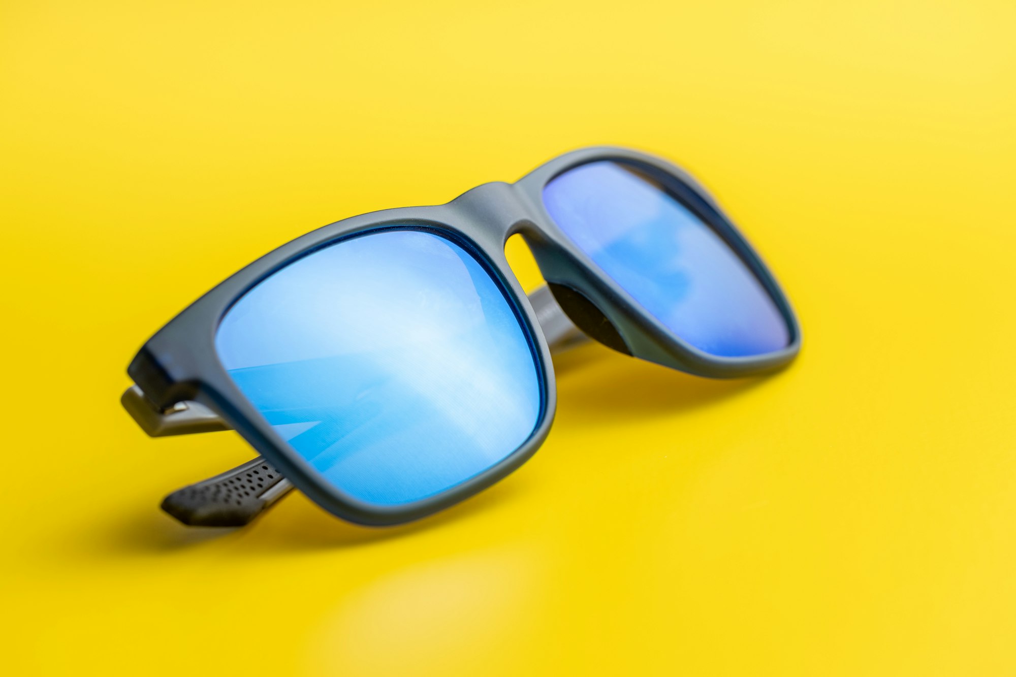 Fashion sunglasses on yellow background.